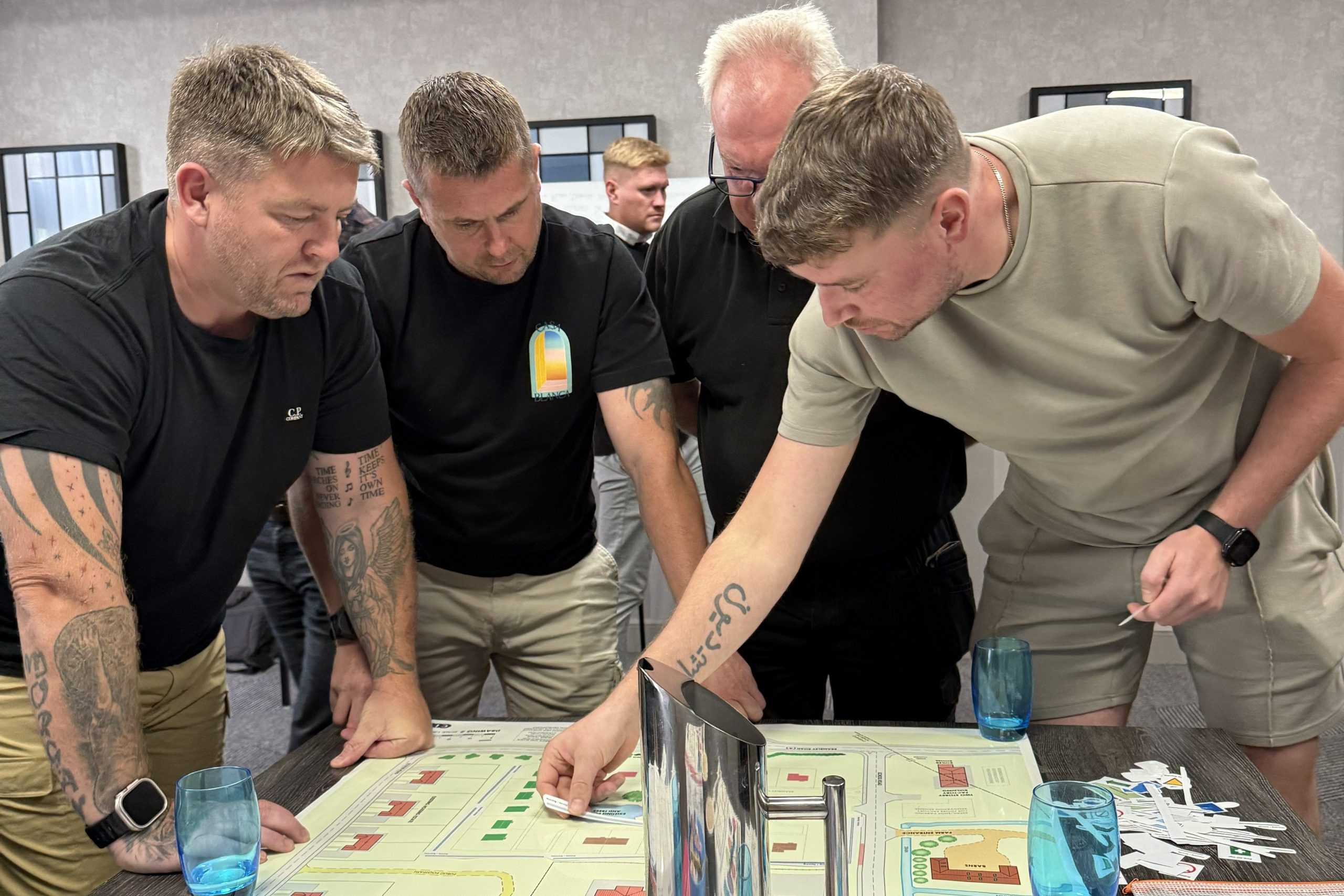 A group of men looking at something as part of a modern apprenticeship with esteem training 